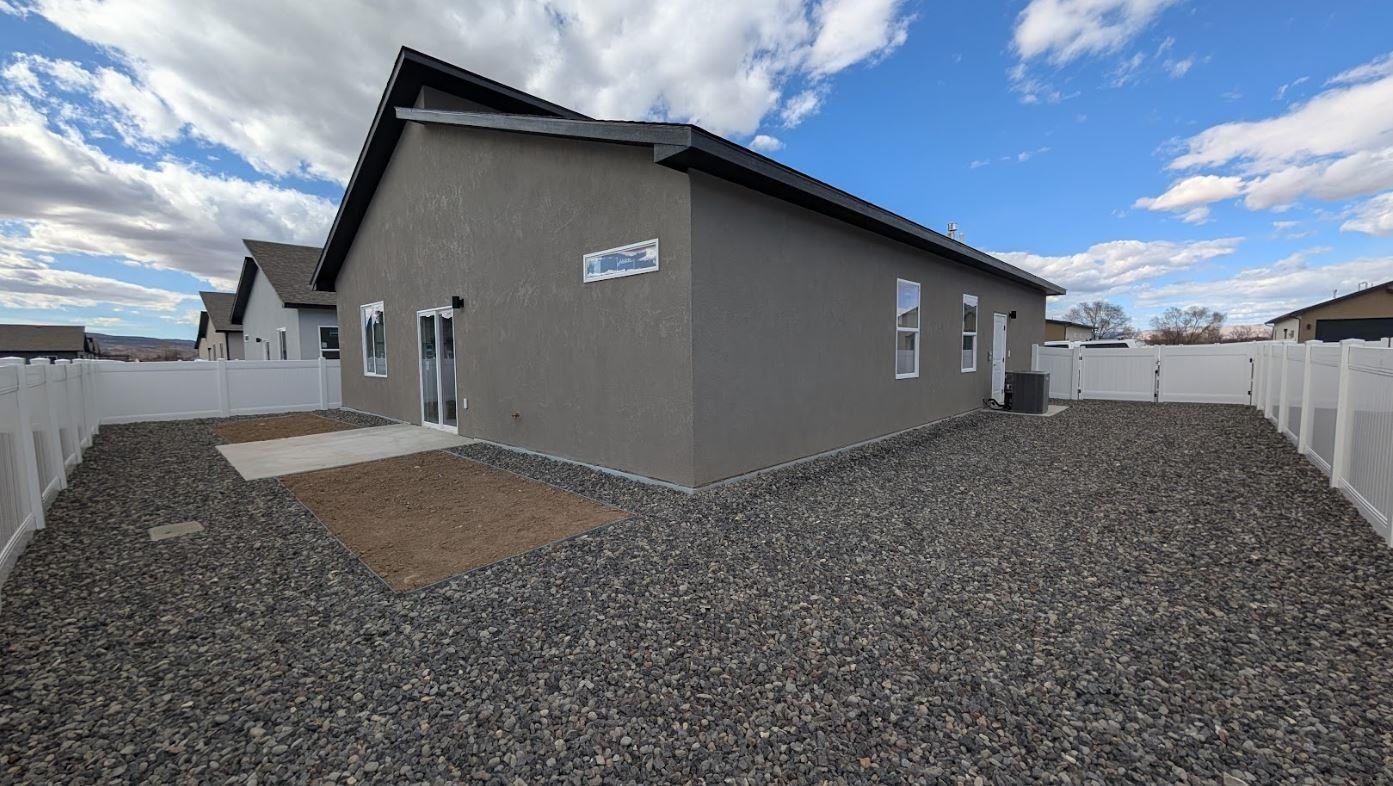 1730 Caliper Way Fruita, CO 81521 - Photo 2 of 15 a backyard of a house with lots of green space
