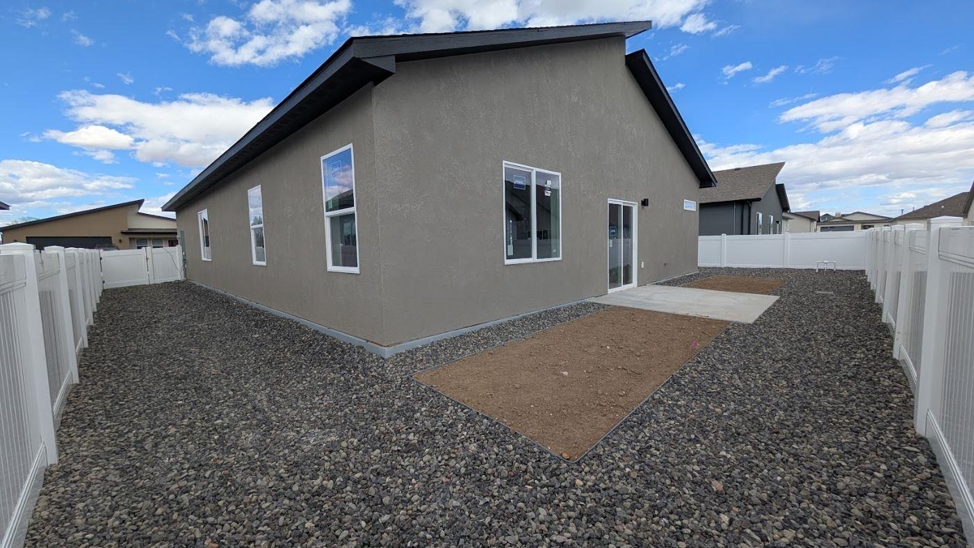 1730 Caliper Way Fruita, CO 81521 - Photo 3 of 15 a backyard of a house with large trees