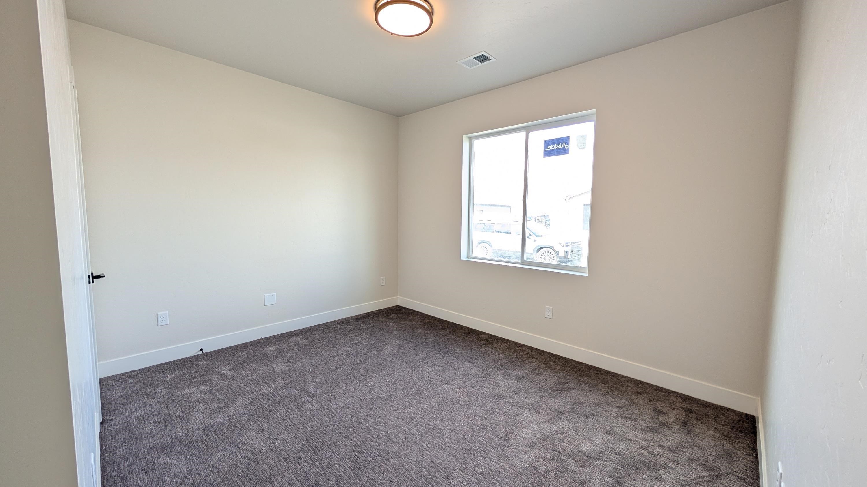 1730 Caliper Way Fruita, CO 81521 - Photo 8 of 15 an empty room with a window