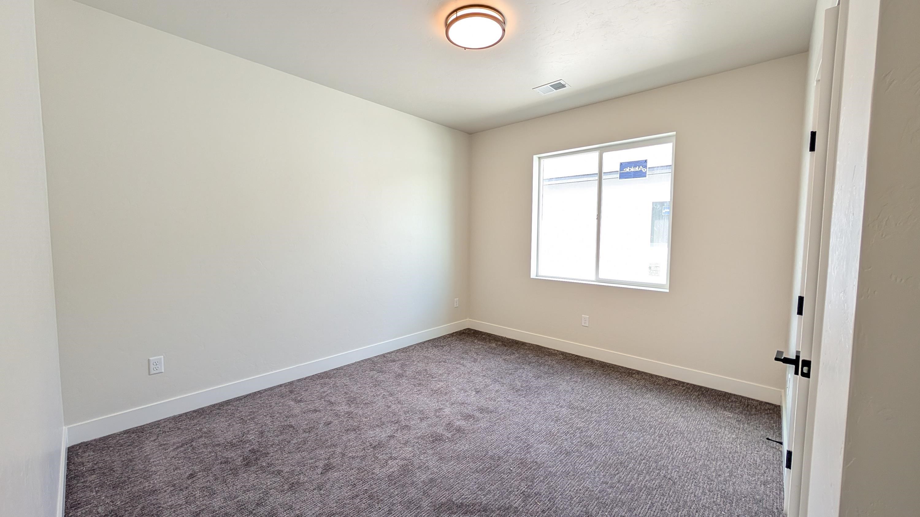 1730 Caliper Way Fruita, CO 81521 - Photo 9 of 15 an empty room with a window