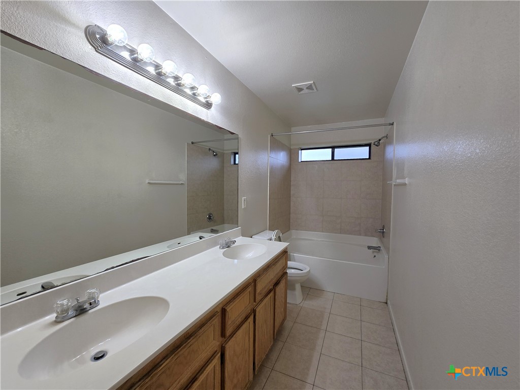 1411 Nicholas Circle, Unit B Killeen, TX 76542 - Photo 16 of 23 a bathroom with a sink double vanity and a mirror