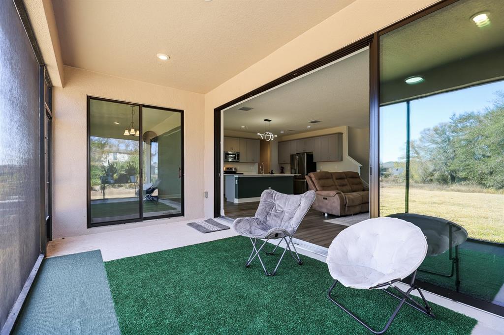 14671 Horse Trot Road Lithia, FL 33547 - Photo 30 of 40 a living room with furniture and a floor to ceiling window