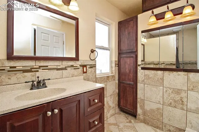 a bathroom with a sink vanity and a mirror