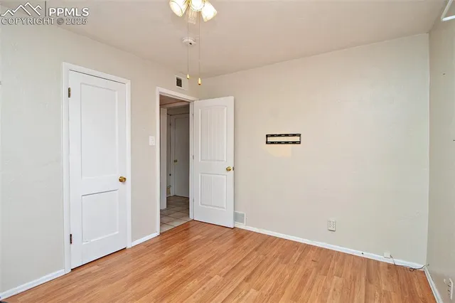 an empty room with wooden floor