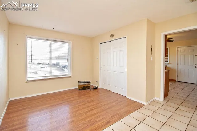 a view of empty room with wooden floor and windows