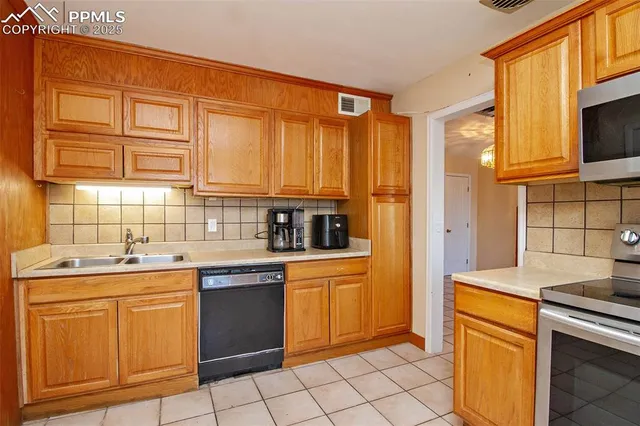 a kitchen with stainless steel appliances granite countertop a sink and cabinets