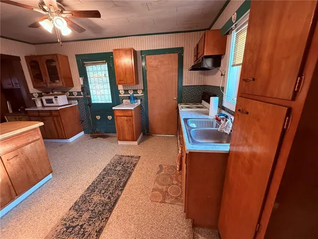 a room with furniture a flat screen tv and a sink