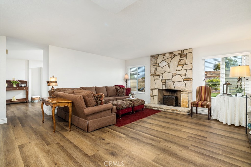 2126 Baseline Road La Verne, CA 91750 - Photo 7 of 39 a living room with furniture a fireplace and a wooden floor