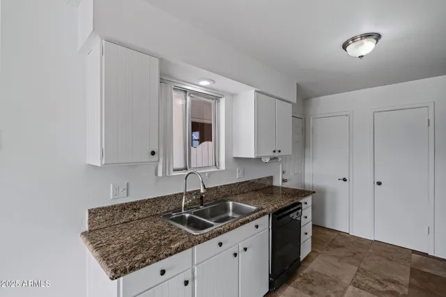 a kitchen with stainless steel appliances granite countertop a sink and a stove