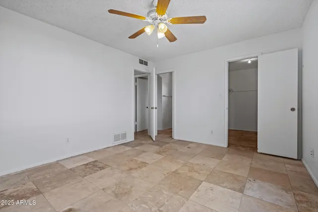 a bathroom with a granite countertop toilet a sink and a mirror