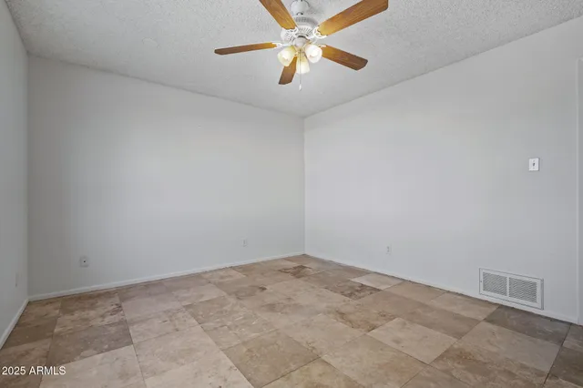 a view of a yard with plants and trees