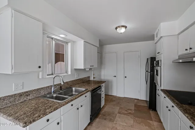 a kitchen with a sink stove and refrigerator
