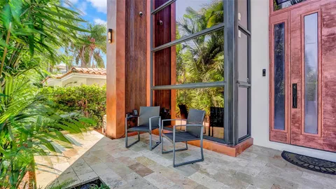 a bed sitting in a bedroom next to a large window