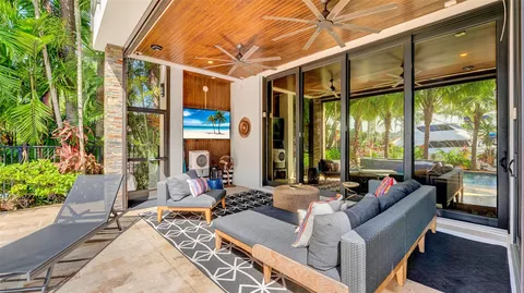 a kitchen with stainless steel appliances kitchen island granite countertop a table chairs and a refrigerator