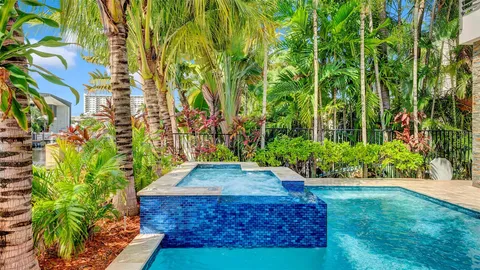 a kitchen with stainless steel appliances a sink stove and refrigerator