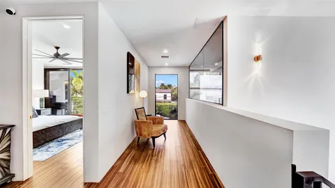 a patio with a table and chairs and potted plants