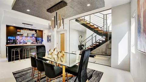 a bedroom with a bed and a large mirror with wooden floor