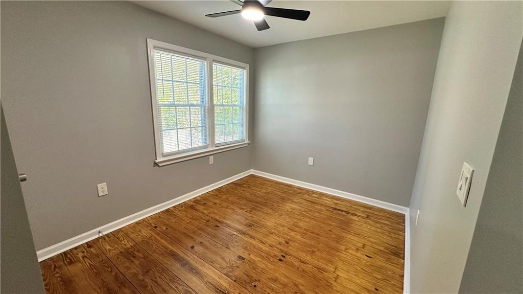 1770 Springview Road Northwest Atlanta, GA 30314 - Photo 11 of 30 an empty room with ceiling fan and window