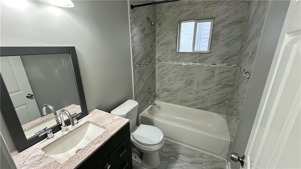 1770 Springview Road Northwest Atlanta, GA 30314 - Photo 13 of 30 a bathroom with a granite countertop toilet sink and mirror