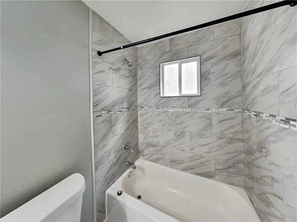 a bathroom with a bathtub and a toilet