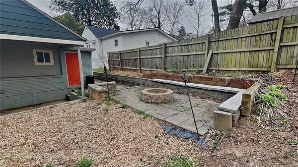 a view of a backyard with sitting area