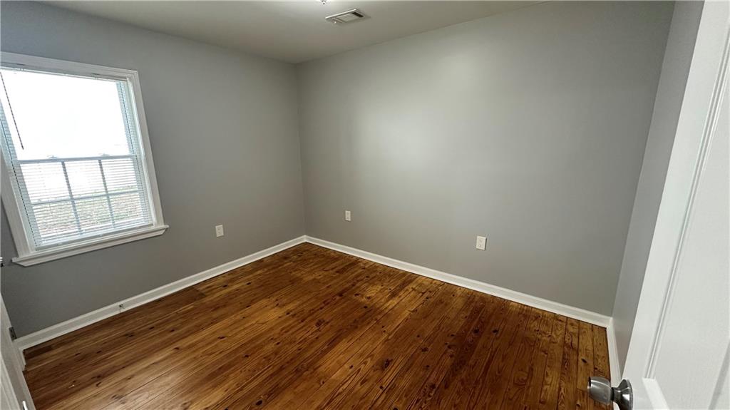 1770 Springview Road Northwest Atlanta, GA 30314 - Photo 24 of 30 an empty room with wooden floor and windows
