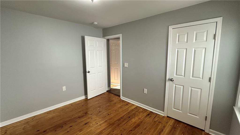 1770 Springview Road Northwest Atlanta, GA 30314 - Photo 25 of 30 an empty room with wooden floor and closet area