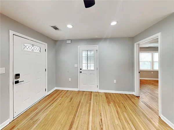 a view of an empty room with wooden floor
