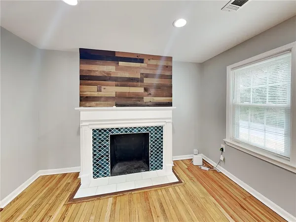 a living room with a fireplace and a table
