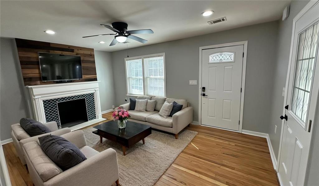 1770 Springview Road Northwest Atlanta, GA 30314 - Photo 5 of 30 a living room with furniture a flat screen tv and a fireplace