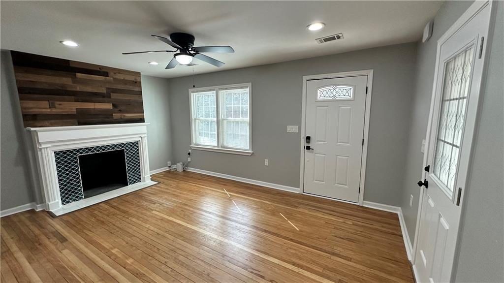 1770 Springview Road Northwest Atlanta, GA 30314 - Photo 7 of 30 a view of an empty room with wooden floor a fireplace and a window