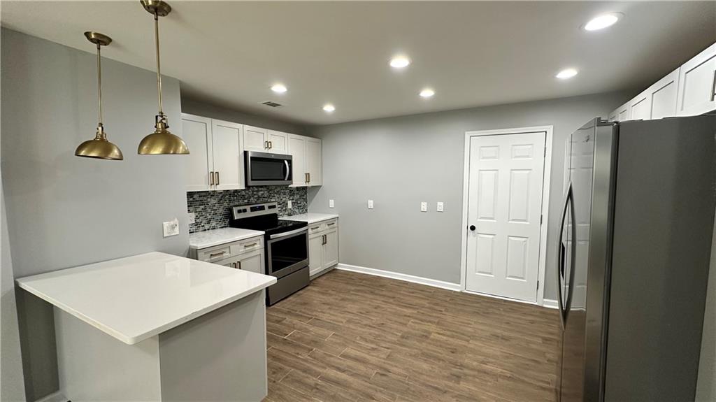 1770 Springview Road Northwest Atlanta, GA 30314 - Photo 8 of 30 a kitchen with a refrigerator a microwave and oven