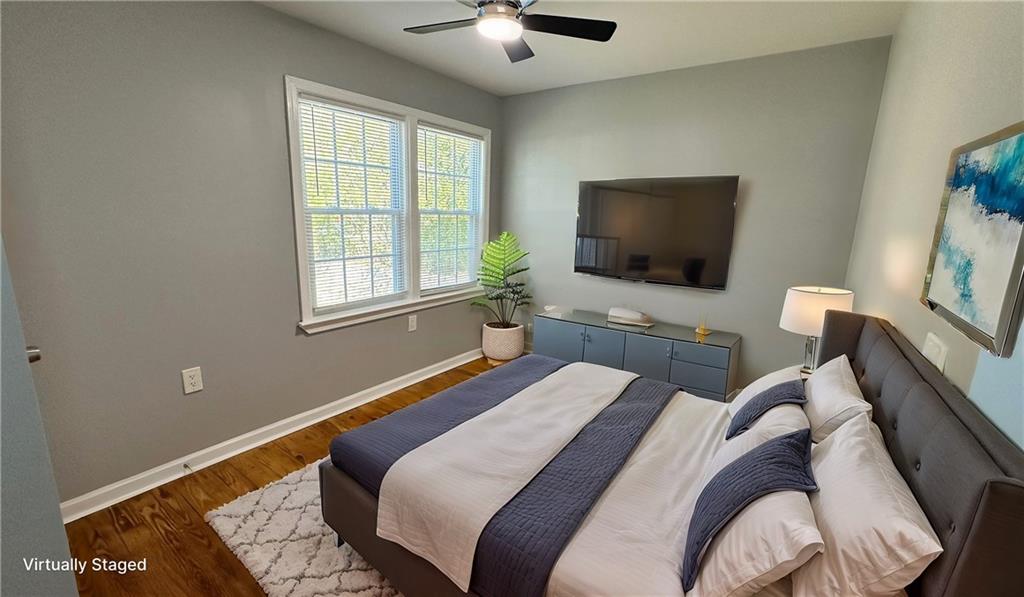 1770 Springview Road Northwest Atlanta, GA 30314 - Photo 10 of 30 a bedroom with bed and a flat screen tv with the potted plant