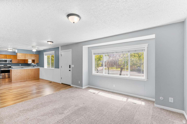 415 East 1150th Street North Logan, UT 84341 - Photo 6 of 38 Open concept living space featuring a wide window with exterior views