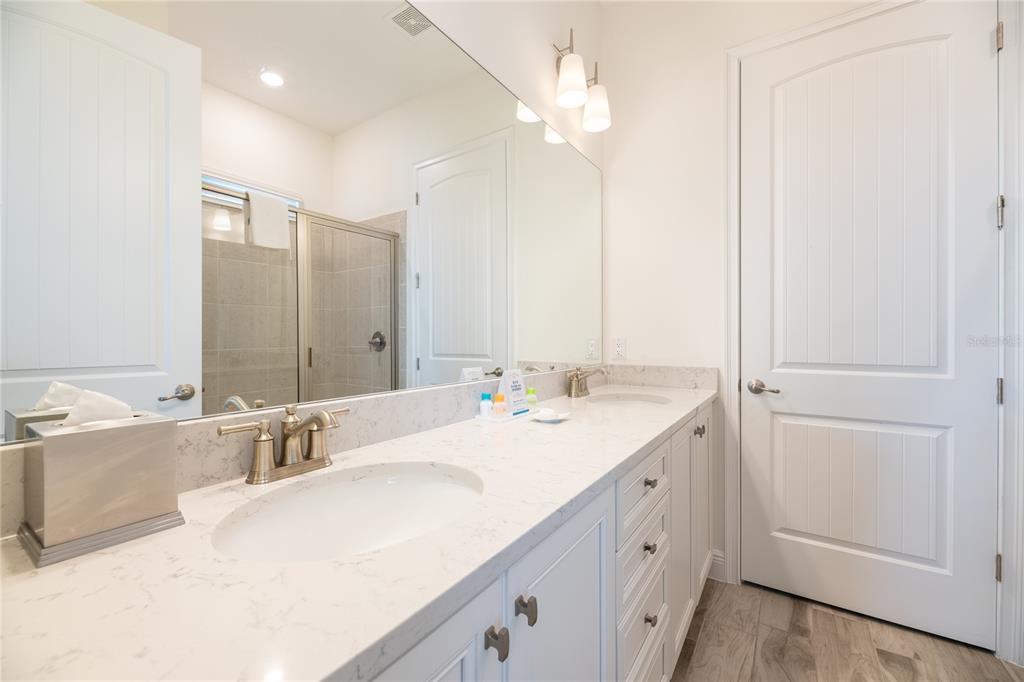 8145 Surf Street Kissimmee, FL 34747 - Photo 18 of 28 a bathroom with a double vanity sink mirror and