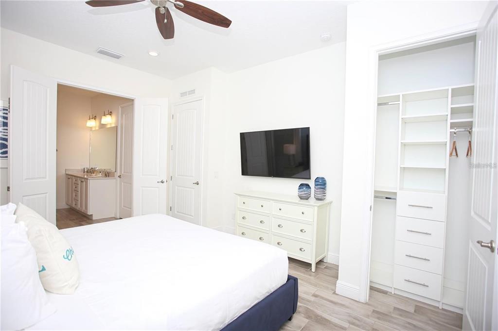 8145 Surf Street Kissimmee, FL 34747 - Photo 20 of 28 a spacious bedroom with a bed and a flat screen tv
