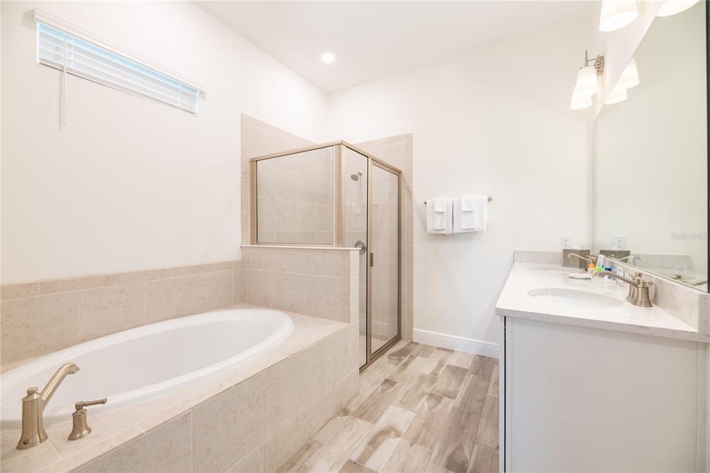8145 Surf Street Kissimmee, FL 34747 - Photo 21 of 28 a bathroom with a bathtub and a sink