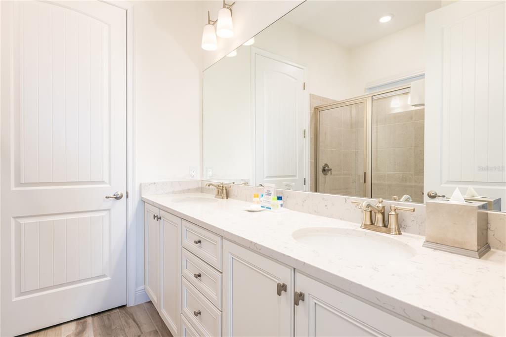 8145 Surf Street Kissimmee, FL 34747 - Photo 23 of 28 a bathroom with a sink and a mirror