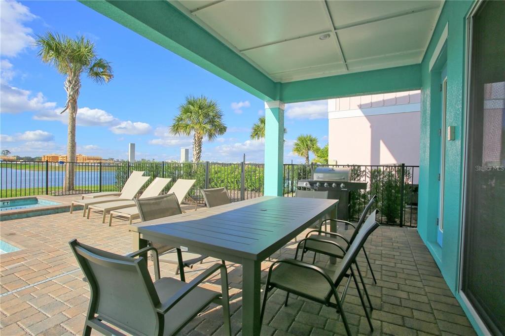 8145 Surf Street Kissimmee, FL 34747 - Photo 24 of 28 a view of a patio with table and chairs and potted plants