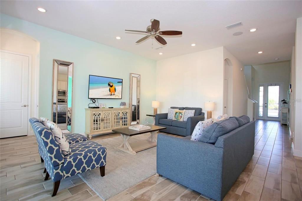 8145 Surf Street Kissimmee, FL 34747 - Photo 5 of 28 a living room with furniture and a ceiling fan