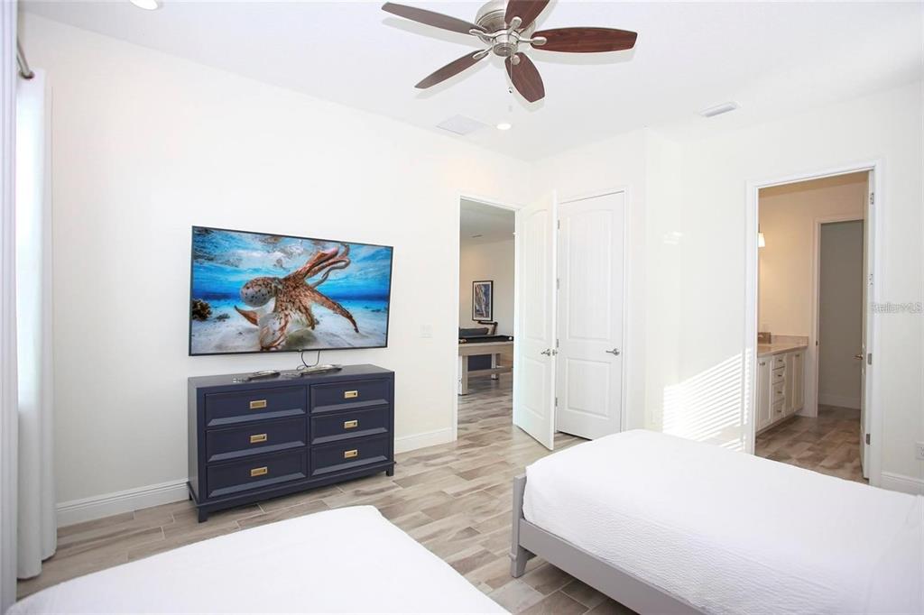 8145 Surf Street Kissimmee, FL 34747 - Photo 10 of 28 a bedroom with a bed and a cabinets