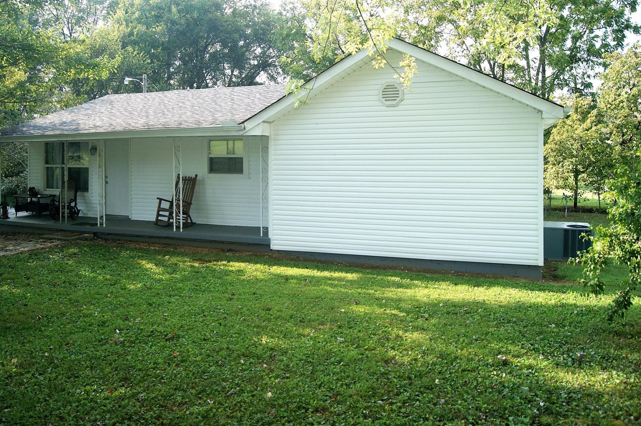 5552 Niles Ferry Road Greenback, TN 37742 - Photo 3 of 30 a view of a white house with a yard potted plants and seating space