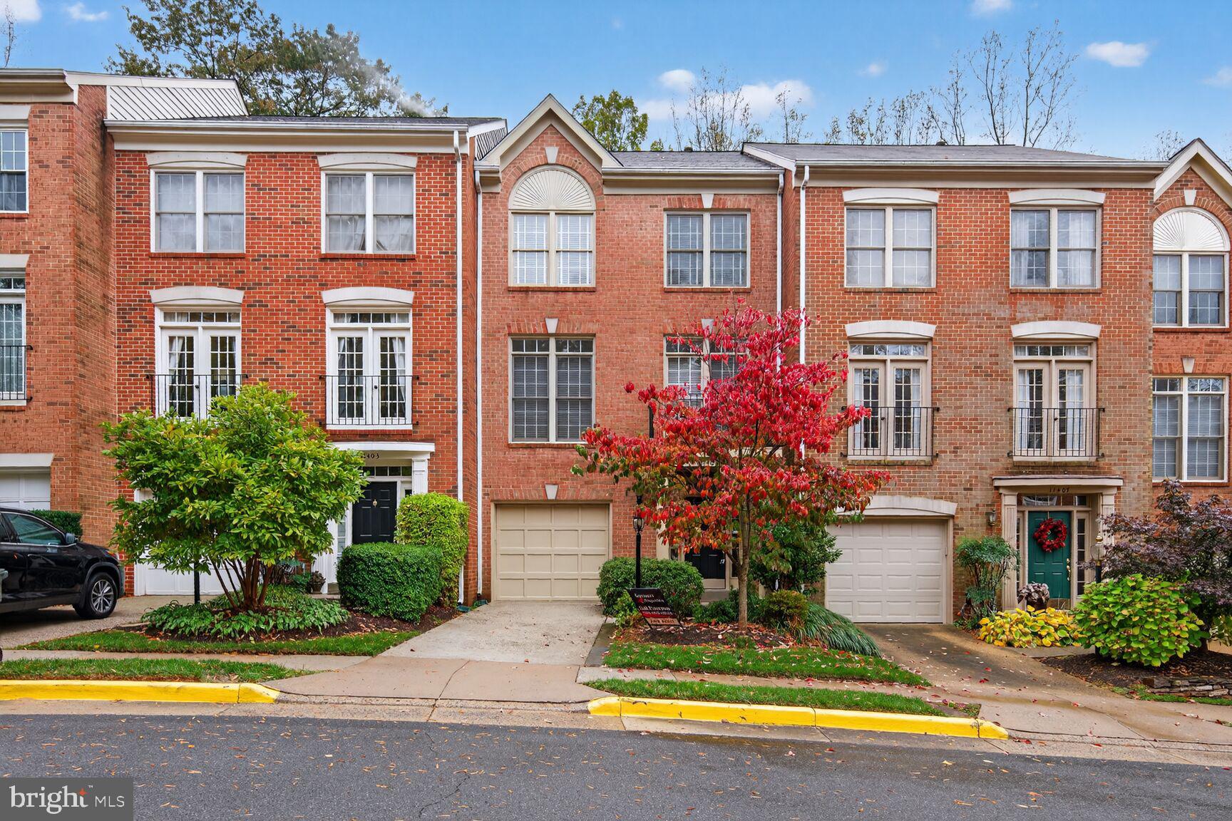 11405 Summer House Court Reston, VA 20194 - Photo 1 of 20 a front view of a house with swimming pool and glass windows and yard