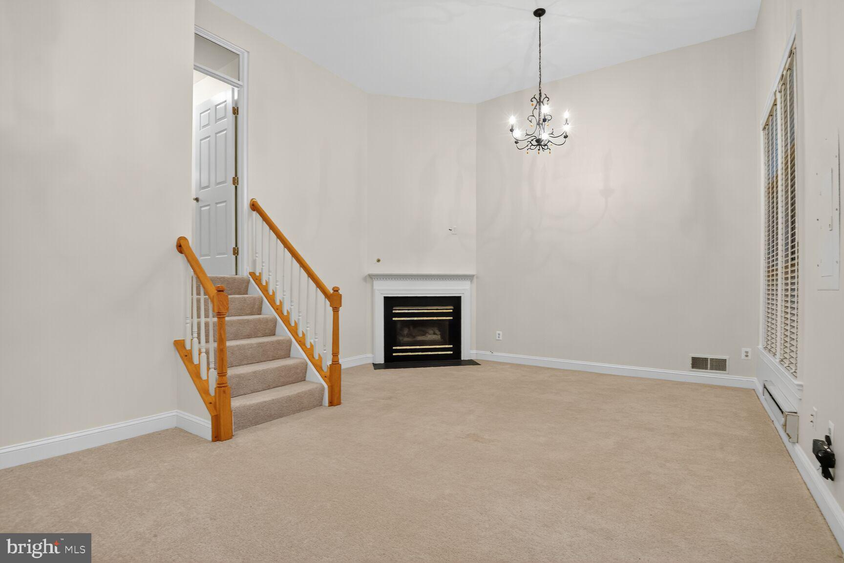 11405 Summer House Court Reston, VA 20194 - Photo 16 of 20 en empty room with stairs and wooden floor