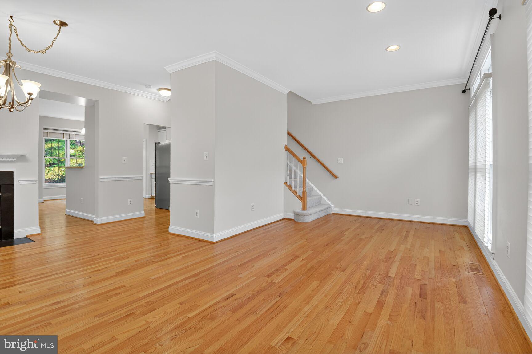 11405 Summer House Court Reston, VA 20194 - Photo 5 of 20 a view of empty room with wooden floor and fan
