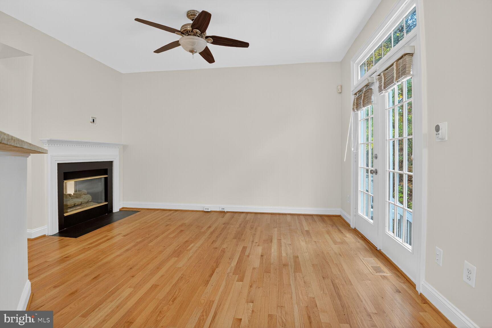 11405 Summer House Court Reston, VA 20194 - Photo 7 of 20 a view of empty room with wooden floor and fan