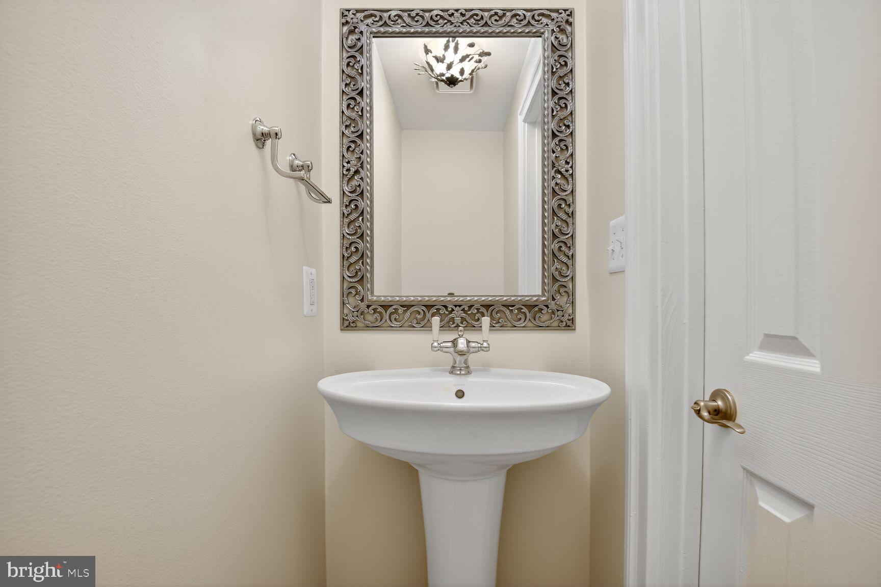 11405 Summer House Court Reston, VA 20194 - Photo 8 of 20 a bathroom with a sink and a mirror