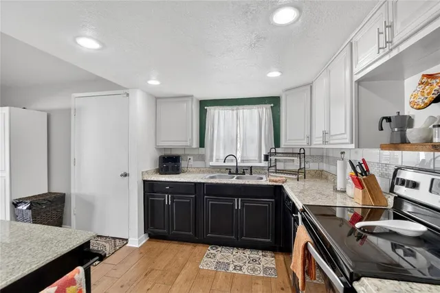 a kitchen with stainless steel appliances granite countertop a stove and a refrigerator