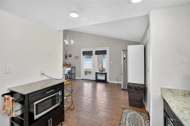 a view of a hallway with wooden floor and closet