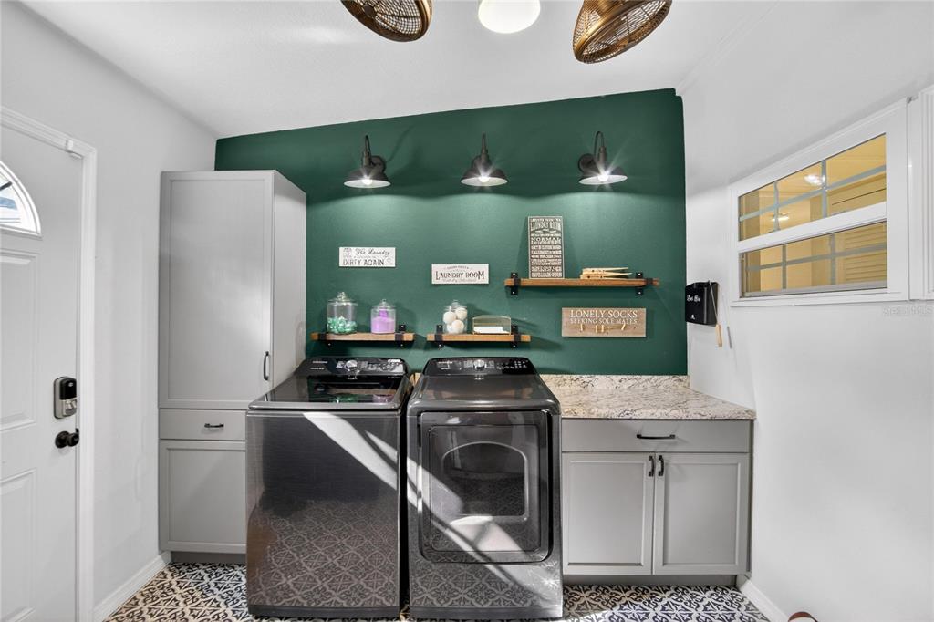 1009 Lenna Avenue Seffner, FL 33584 - Photo 15 of 68 a kitchen with stainless steel appliances granite countertop a stove and a refrigerator